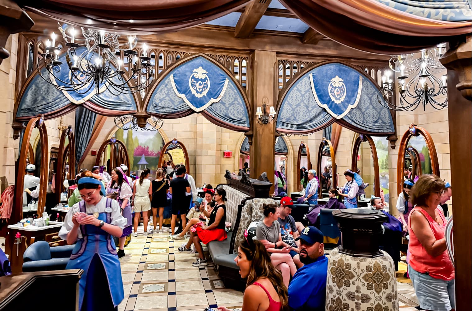 A child in a princess makeover in front of the Disney castle